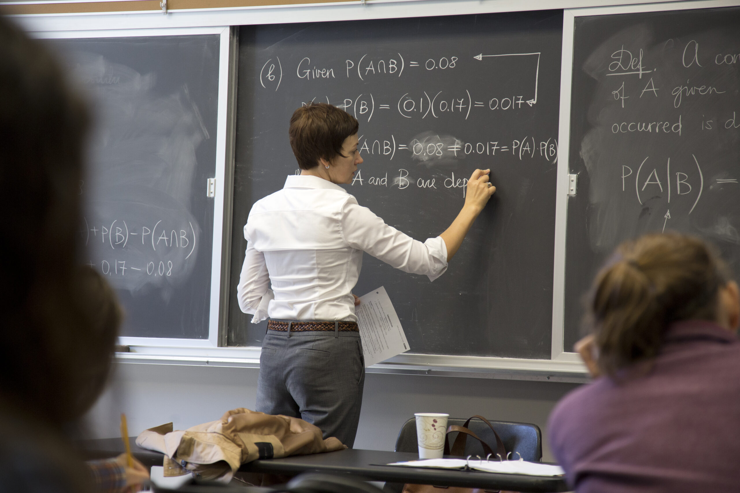 Dr. Asta Shomberg explains mathematical concepts to students.